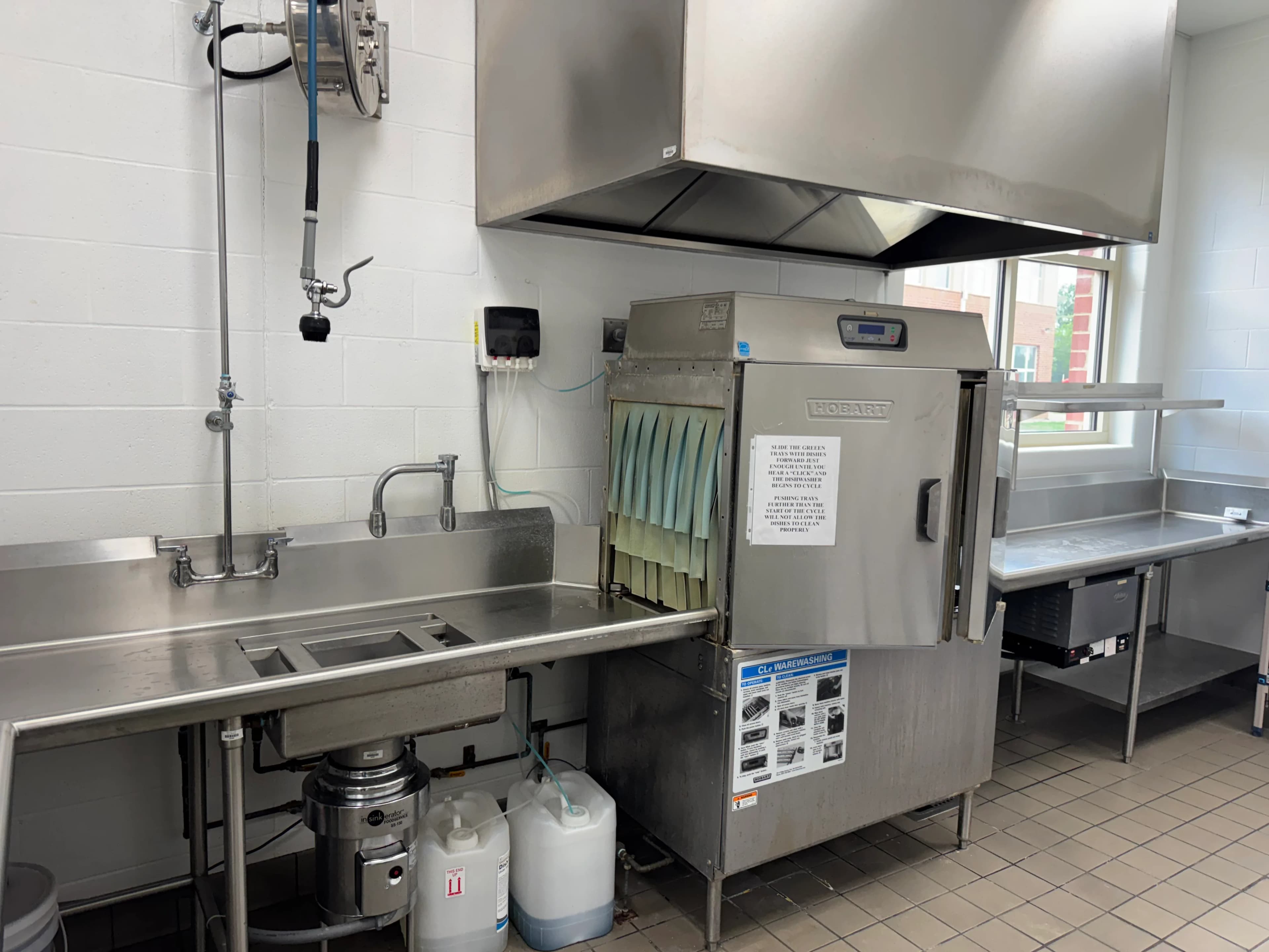 A brand-new stainless cooking suite installed in an institutional kitchen