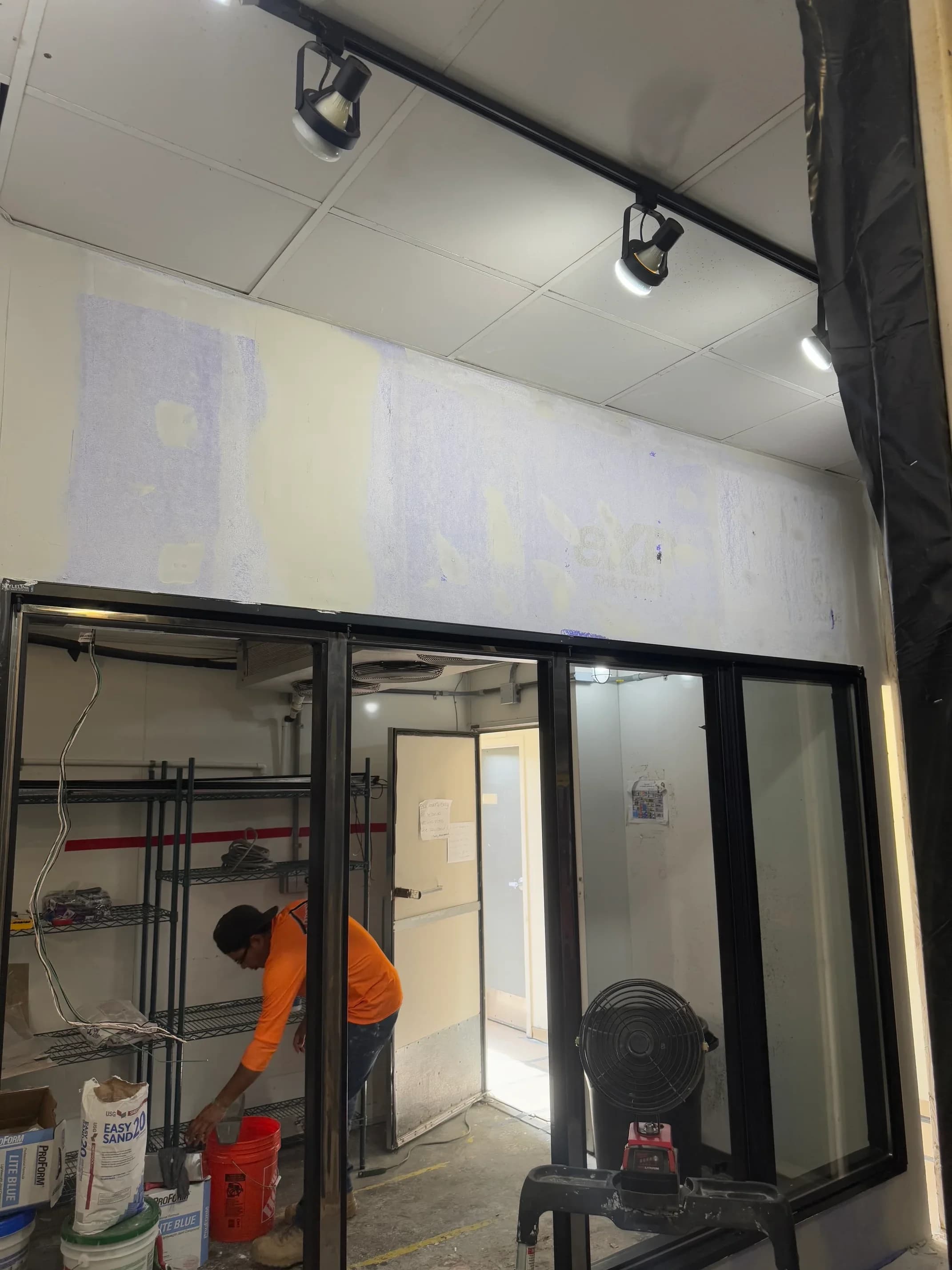 A convenience-store beverage and cooler wall serviced during a remodel