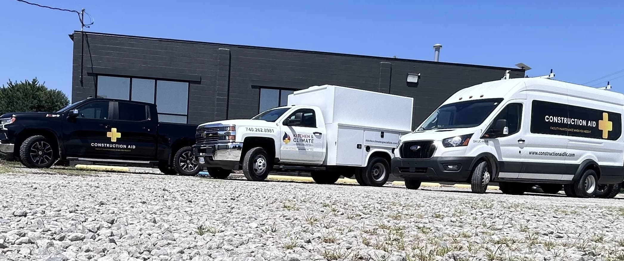 Kitchen & Climate Specialists service trucks parked outside the shop
